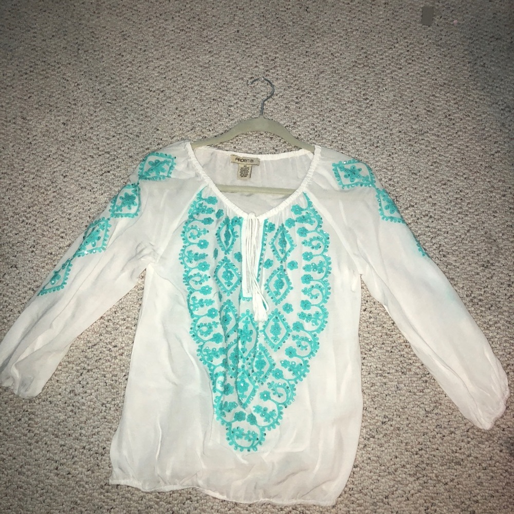 white shirt with teal embroidery